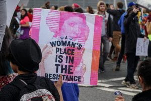 a picture of a sign that reads A Women's Place is in the Resistance
