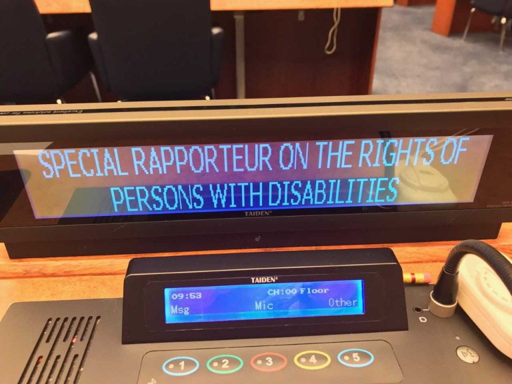 a picture of the rapporteur sign on the UN floor
