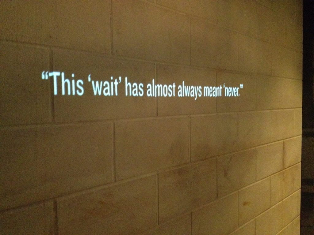 a photo of a line from the Letter from a Birmingham Jail which reads "this wait has almost always meant never"