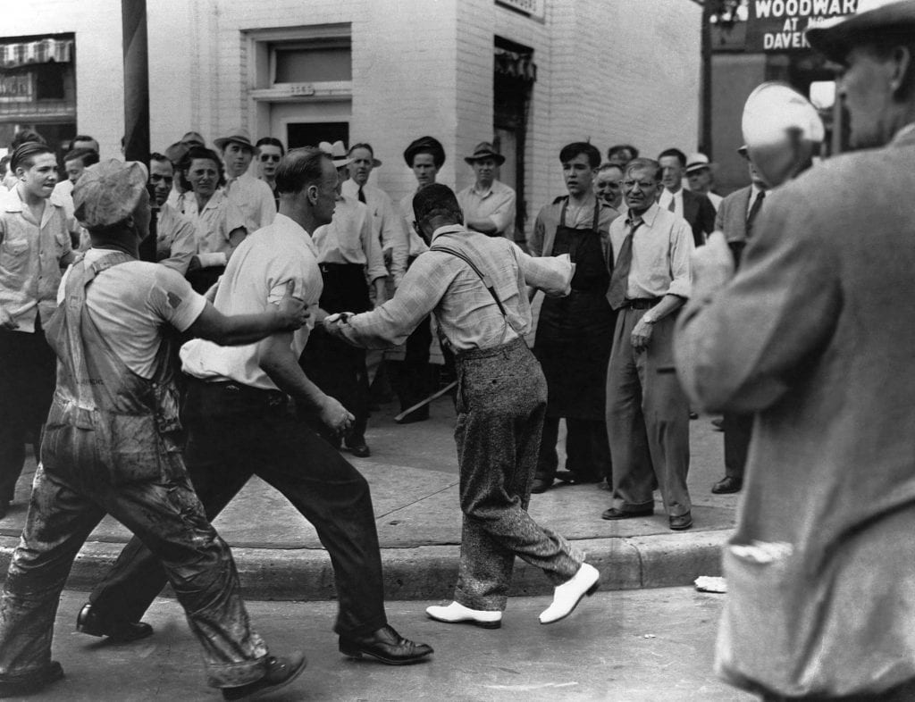 An African American man, the victim of assault during Detroit's race riot tries to escape from a mob before further violence ensues.