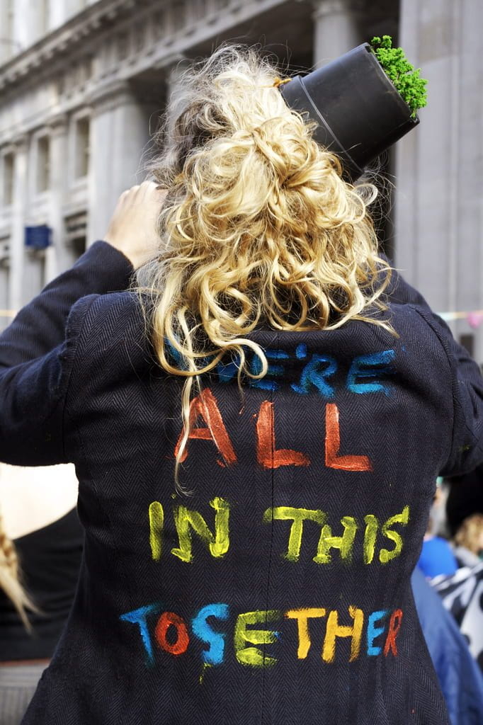 a photo of a jacket that reads "we're all in this together"