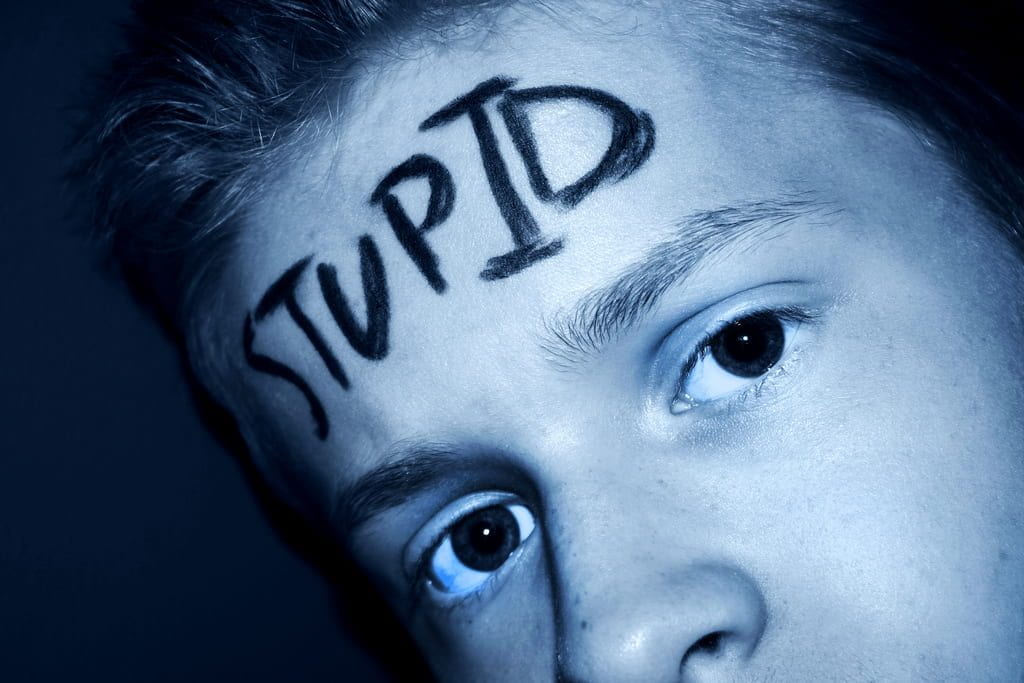 a picture of a boy with 'stupid' written across his forehead