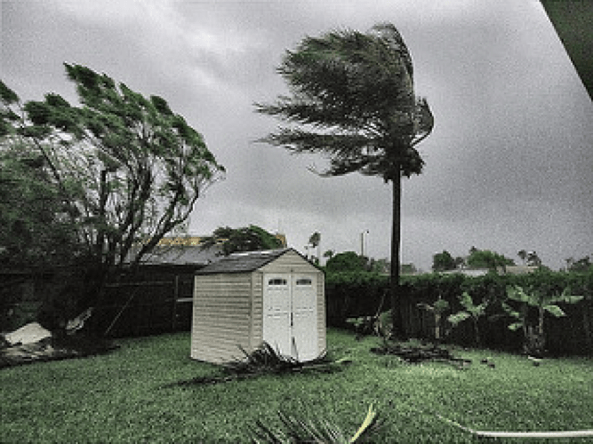 Storage building photographed with Hurricane Irma in the background