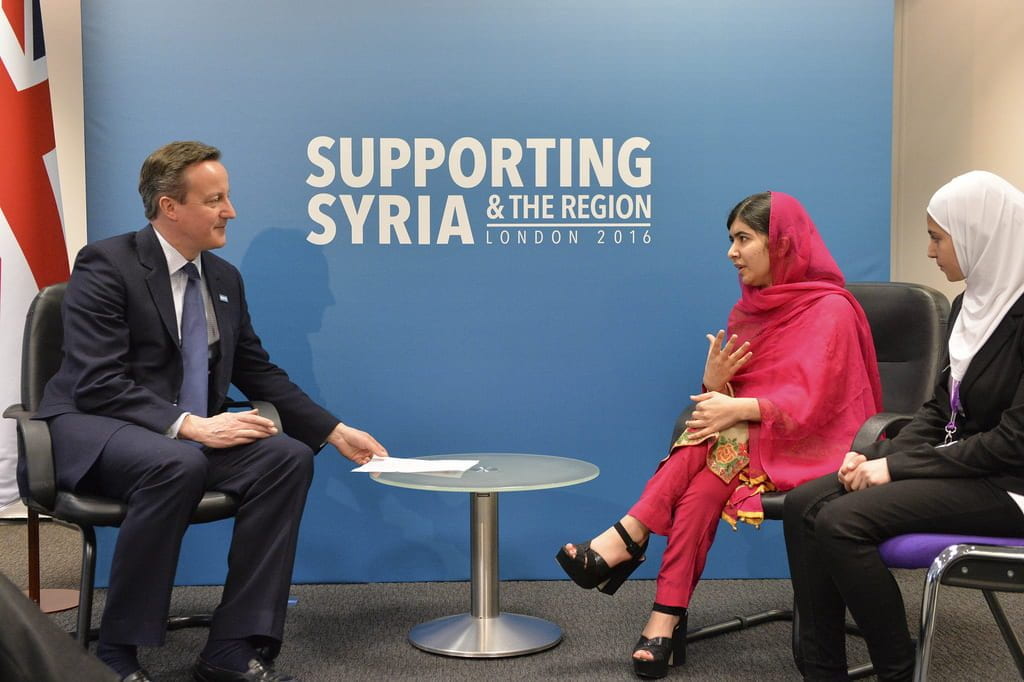 Malala sits and speaks with David Cameron at a conference about Syria