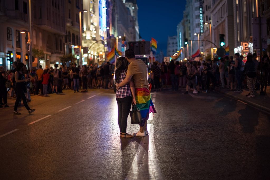 A couple embraces in the street during a gay pride demonstration. 
