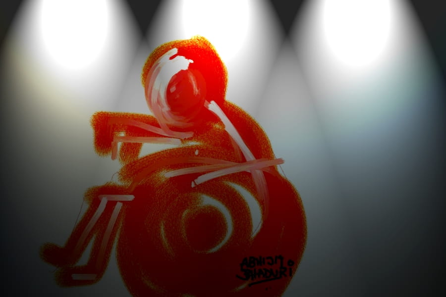 This image shows a red figure in a wheelchair that appears to be made by fingerpainting. There are three lights shining at the top of the image. 