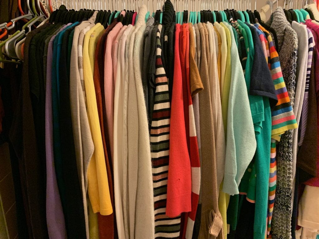 a photo of clothes hanging in a closet