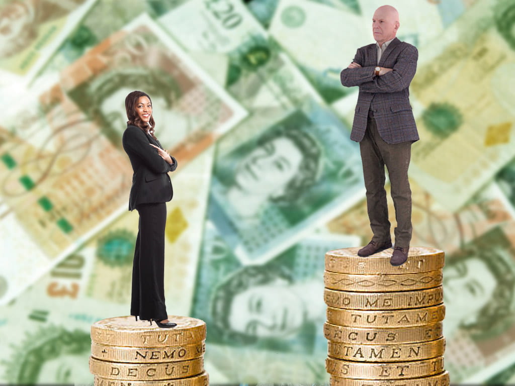 Women and man standing on unequal sized stacks of coins