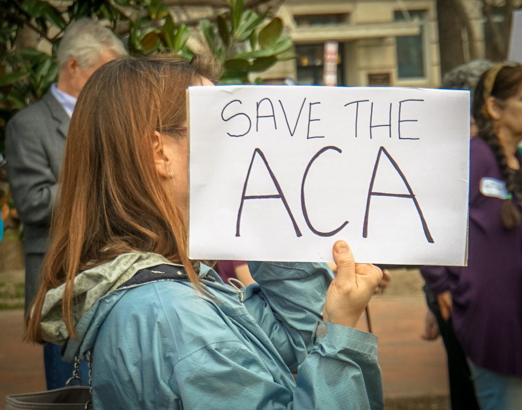 a photo that reads "Save the ACA."