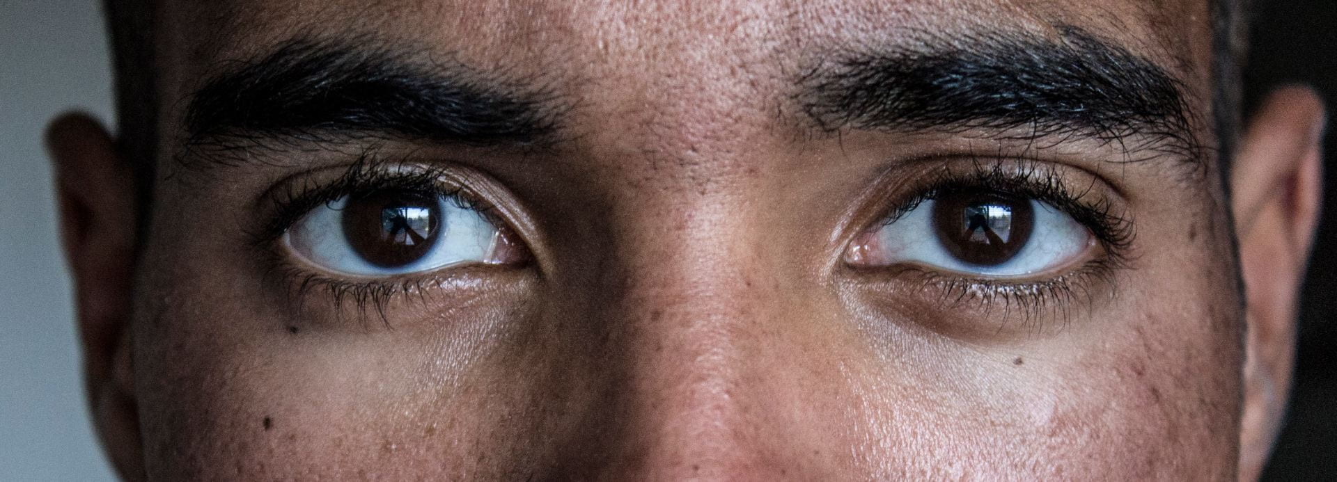 A persons eyes, looking directly into the camera.