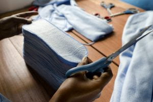 A worker trims and stacks sanitary pads before they are lined and sewn at the Afripads factory. 