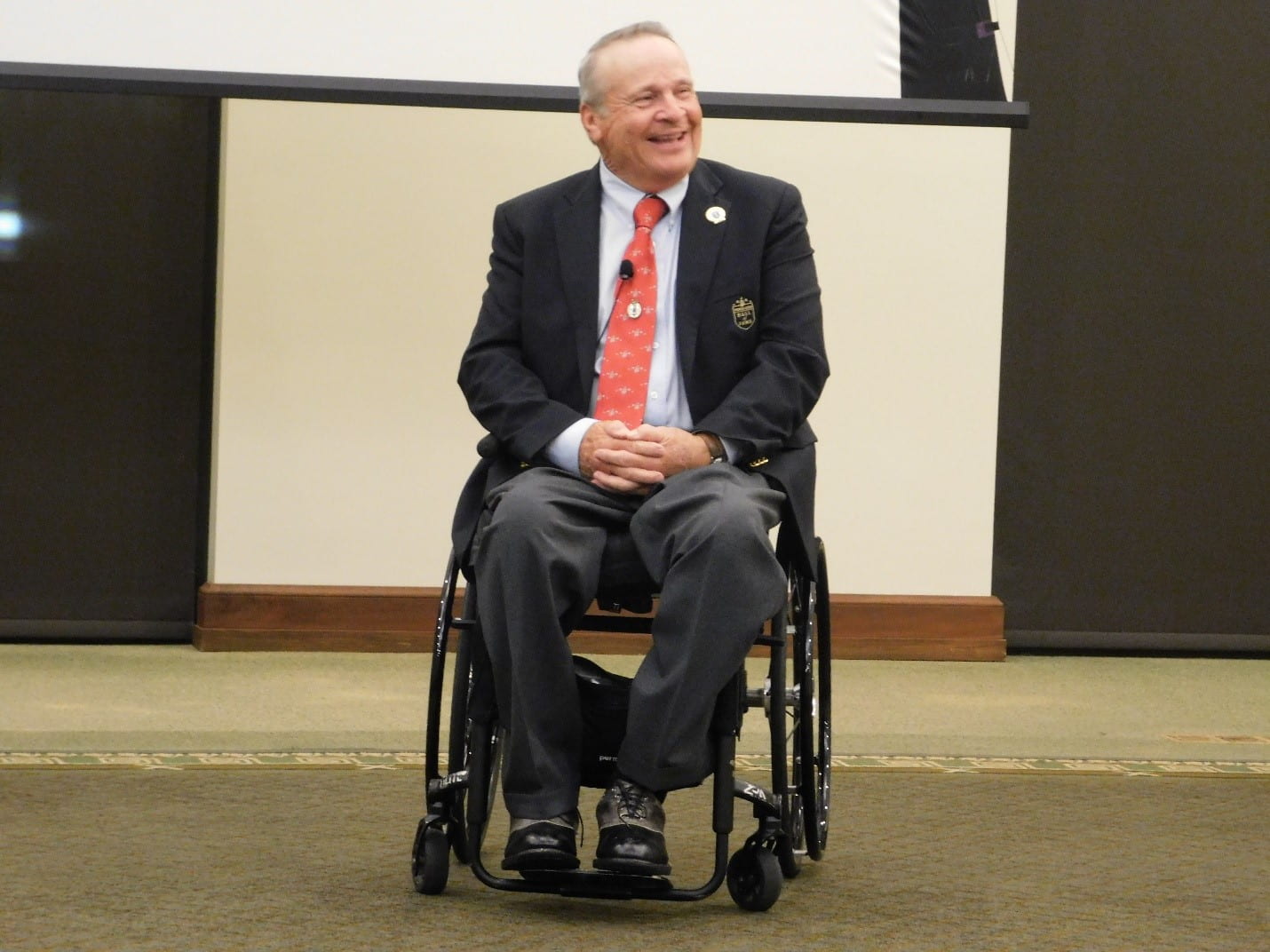 This is a picture from the event of Walters smiling as he speaks to the audience.