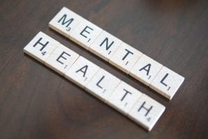 Scrabble pieces spell out the words "mental health."