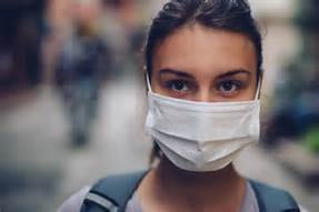 A picture of a girl with a surgical mask covering her mouth and nose