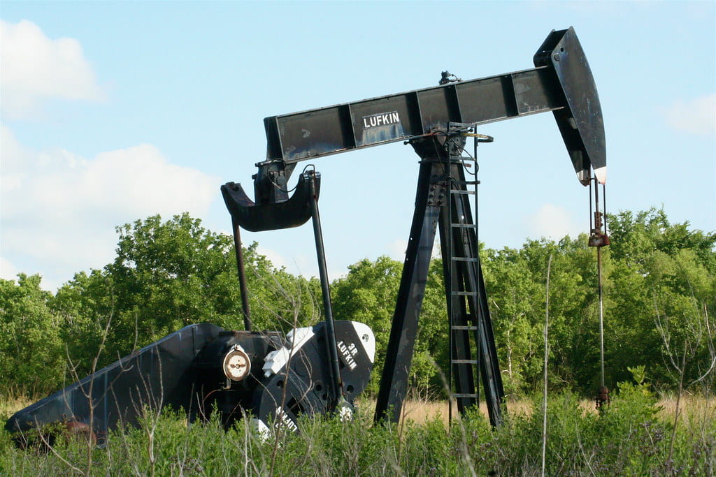 An image of an oil well, colored black, in the process of digging for oil. Located in Lufkin, Texas.