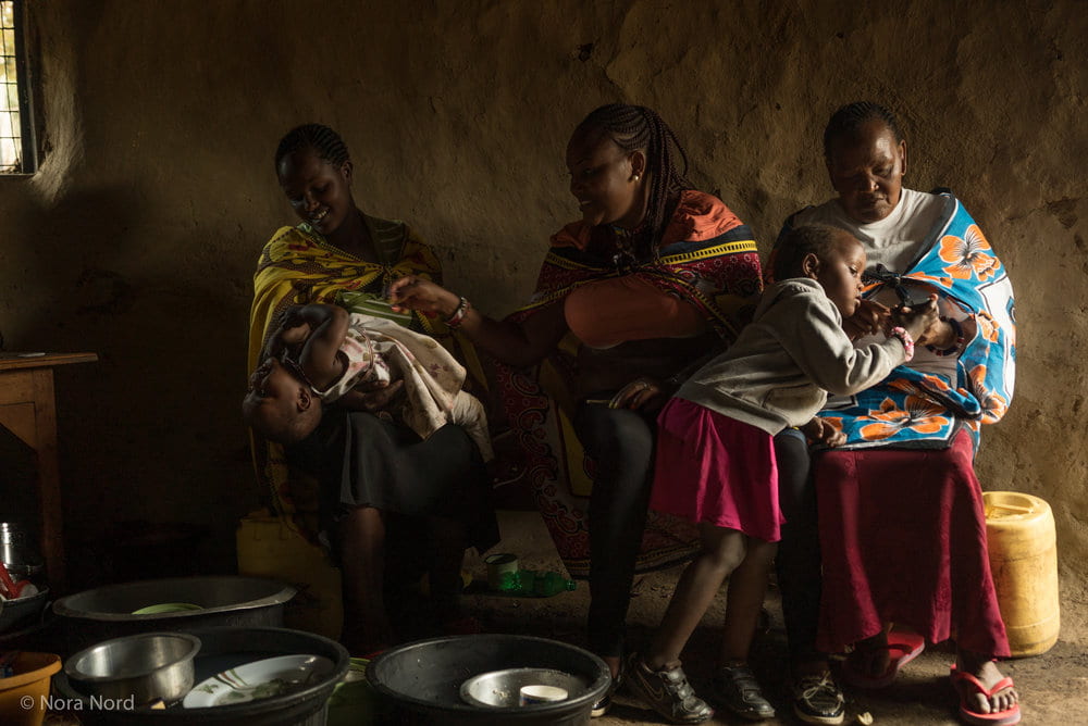 Women and children talking in Maasai house.