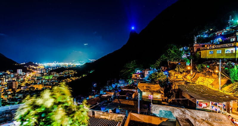 Rio favela at night as the Christ the Redeemer statue looks on.