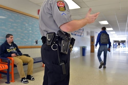 Photo of police officer in a school hallway
