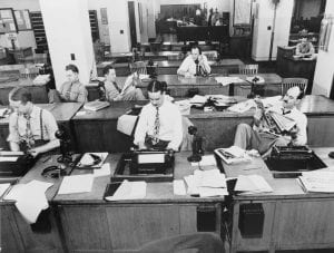Black and white photo of the New York Times newsroom in 1942, Men in suits sit behind desks