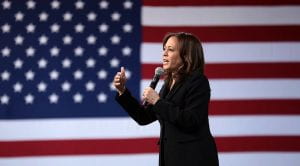 Image of Kamala Harris speaking in front of an American flag