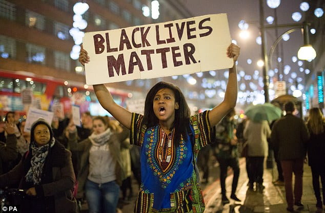 Woman holding a Black Lives Matter sign.