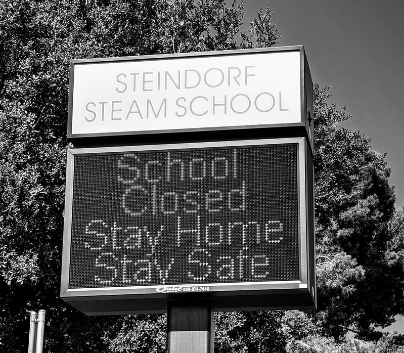 School sign reading "school closed, stay home, stay safe."