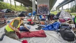 An image portraying an encampment under a bridge