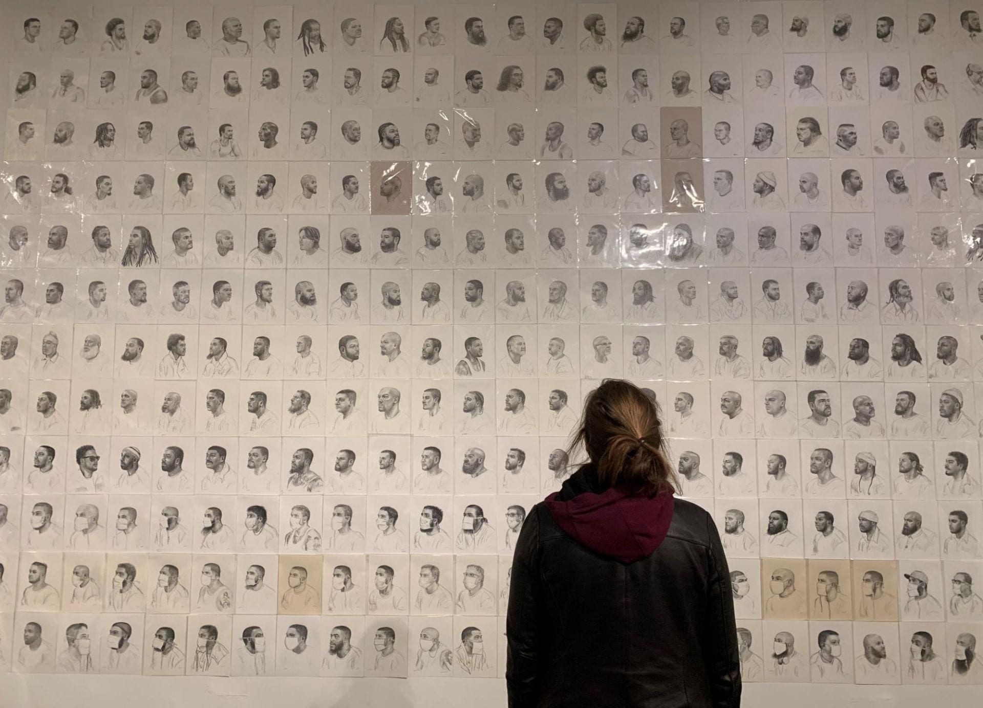 Girl in front of Pyrrhic Defeat: A Visual Study of Mass Incarceration by Mark Loughney