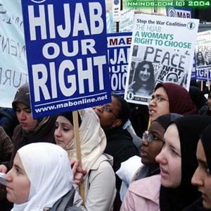 Women in hijabs at a protest with signage "Hijab our Right"
