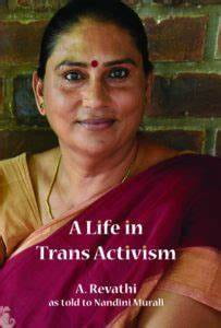 A picture of an Indian woman named Revathi wearing a maroon saree with gold jewelry. She has a gold stud in her nostril piercing and a red bindi between her eyebrows. White text reads, “A Life in Trans Activism, A. Revathi as told to Nandini Murali”