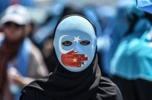Women wearing mask in solidarity with Uyghur Muslims