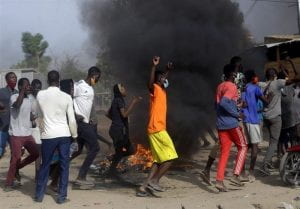 Protestors burning things in a demonstration in the streets of Chad. 
