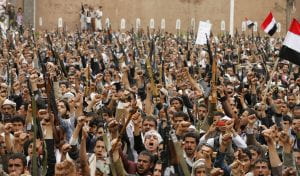 Protestors holding guns chanting something in Yemen 