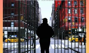 Photo of man standing at an open gate facing the city