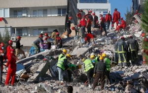 Members of rescue services search for survivors in the debris of a collapsed building in Izmir, Turkey, Saturday, Oct. 31, 2020. Rescue teams on Saturday ploughed through concrete blocs and debris of eight collapsed buildings in Turkey's third largest city in search of survivors of a powerful earthquake that struck Turkey's Aegean coast and north of the Greek island of Samos, killing dozens Hundreds of others were injured. (AP Photo/Darko Bandic)