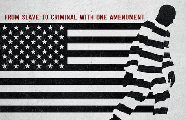 Alt text: An image with an American flag in black and white with an African American person walking across it in black and white stripes, with the words, “FROM SLAVE TO CRIMINAL WITH ONE AMENDMENT” reading across the top.