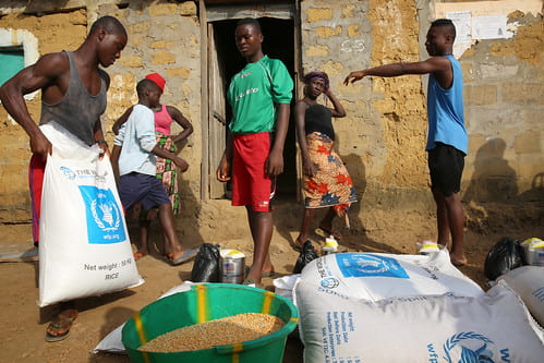 An image of Kenyans sorting through the food assistance provided by the United Nations World Food Program.