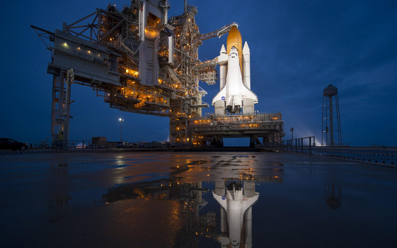 Photo of space shuttle near body of water.