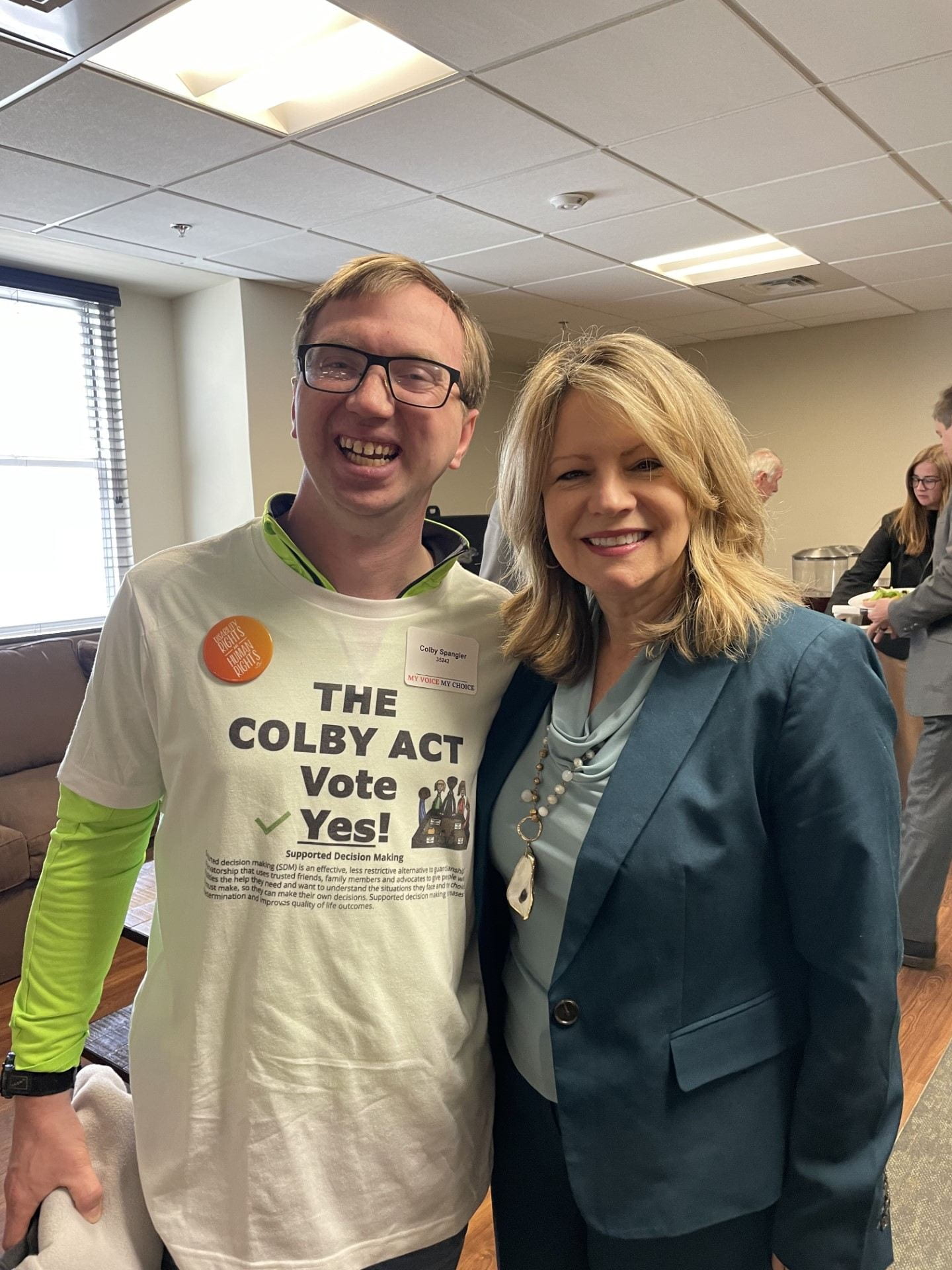 Colby wearing a shirt that says "The Colby Act, vote yes!" next to Representative Cynthia Almond of Tuscaloosa.