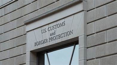 Engraved sign on a concrete building that reads " U.S. Customs and Border Protection."