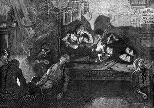 Several Chinese immigrants sit beside each other inside a dark and smoky Opium Den, some of them passed out or laid back.