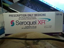 A box of Seroquel in front of a laptop.
