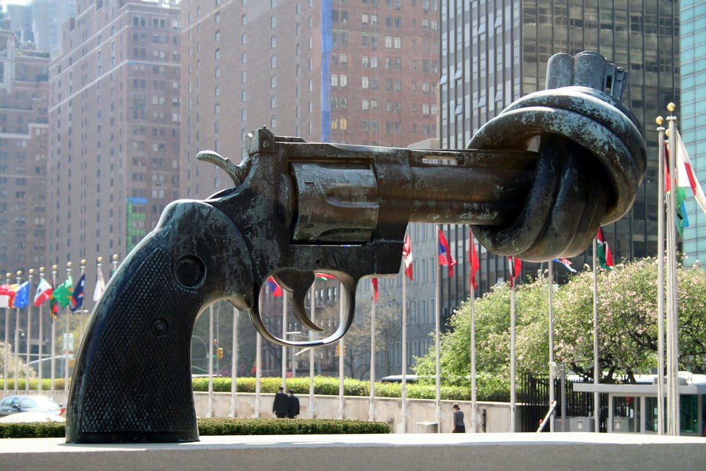The Knotted Gun sculpture displayed in front of the UN building in New York. The Knotted Gun is a metal sculpture of a gun with the barrel of the gun twisted into a knot.